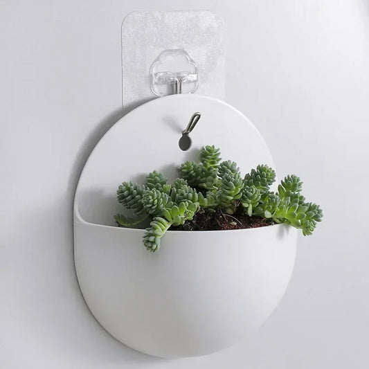 Stylish wall-mounted hanging planter filled with green plants, ideal for home garden and balcony décor
