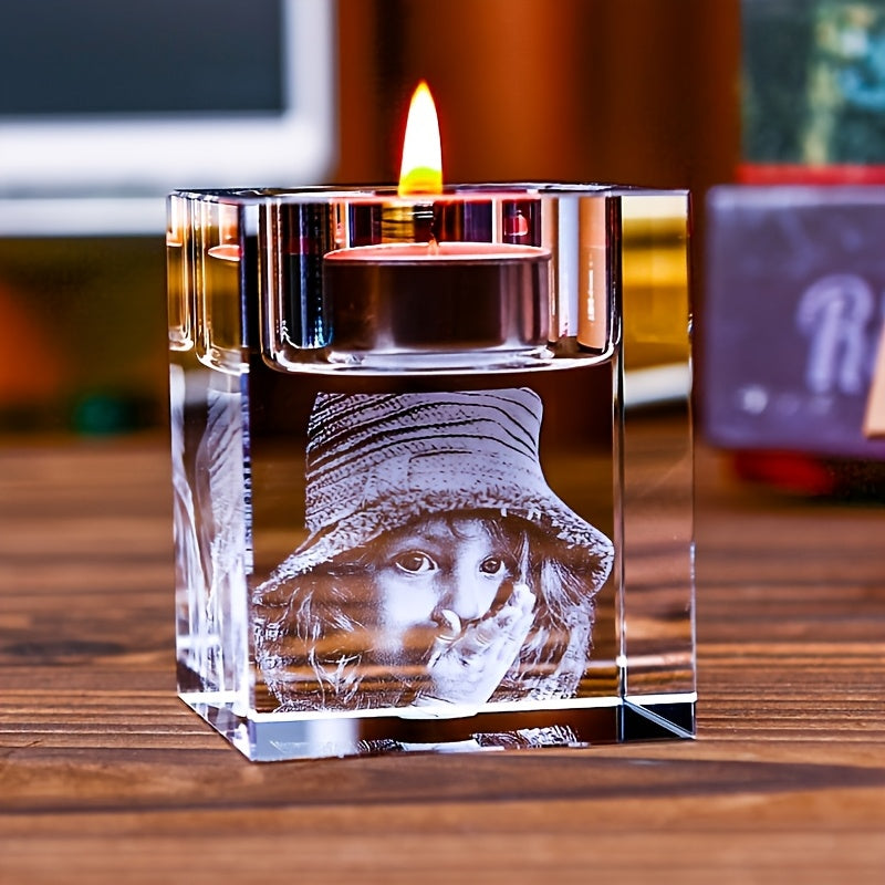 Personalized glass candle holder with candle lit inside, creating a warm glow