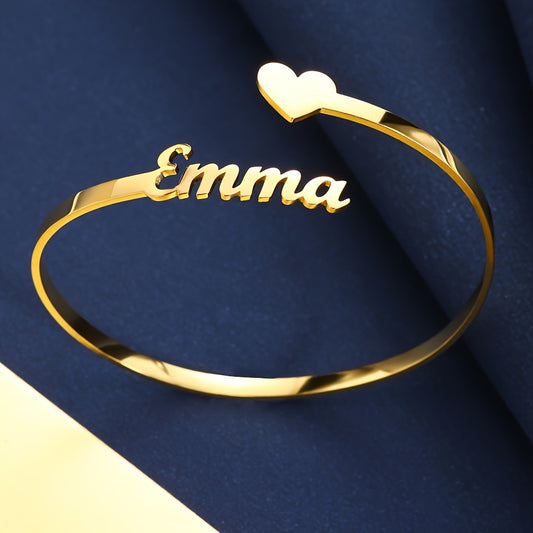 Elegant and minimalistic, this custom name bracelet in a golden-tone finish features a delicate heart charm—perfect for daily wear or special occasions.

