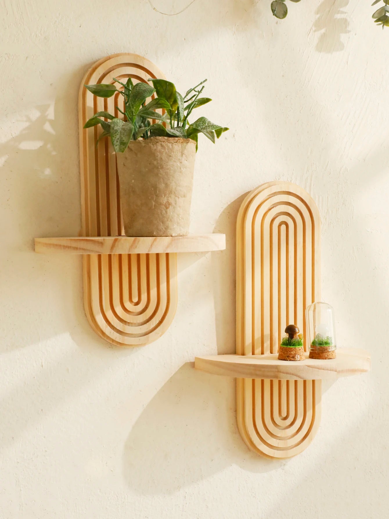 Geometric wooden wall-mounted shelf with a boho design, perfect for displaying plants, decor, and personal items in living rooms or bedrooms.