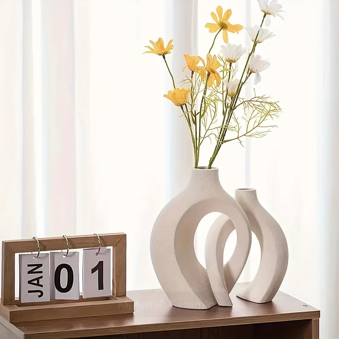 Minimalist hollow ceramic vases for flower arrangements, perfect for adding a modern and chic touch to home decor.