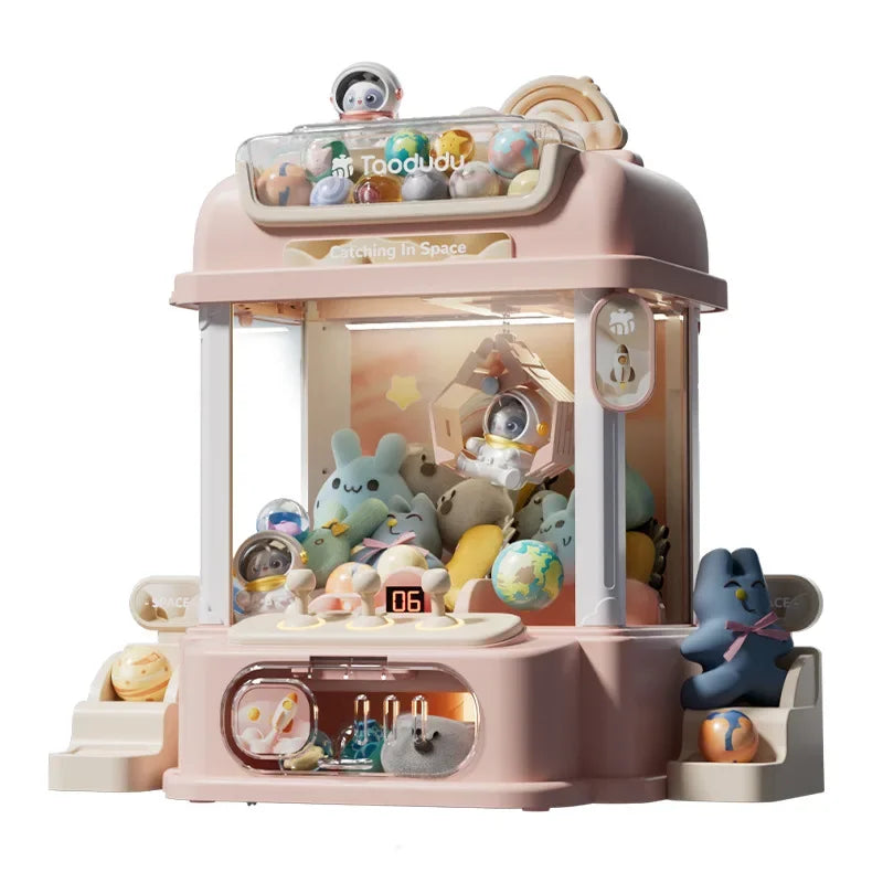 Close-up view of the DIY claw machine showing the joystick controls and prize-catching mechanism for kids.