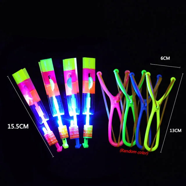 Amazing LED light arrow toy flying through the night sky, creating a bright and colorful glowing effect during outdoor play.