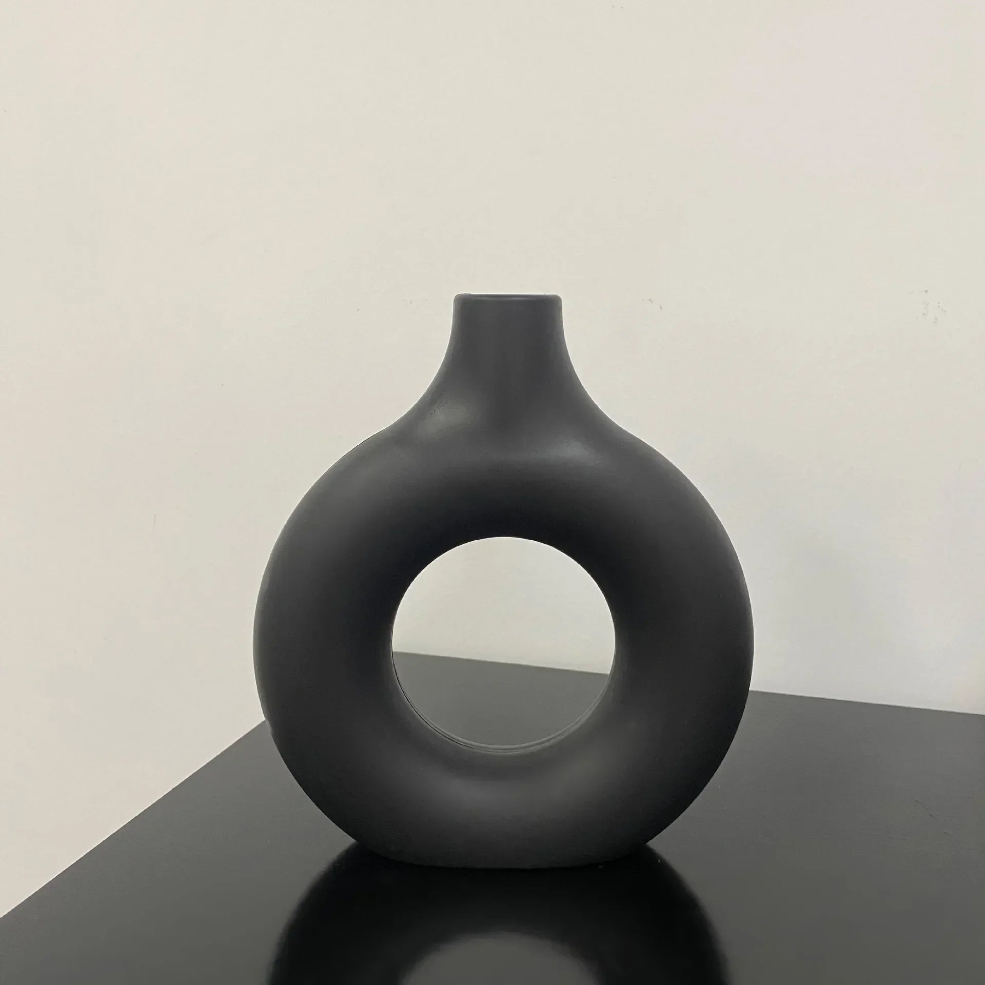 Single branch flower arrangement in the imitation ceramic white vase, showcasing minimalist decor.