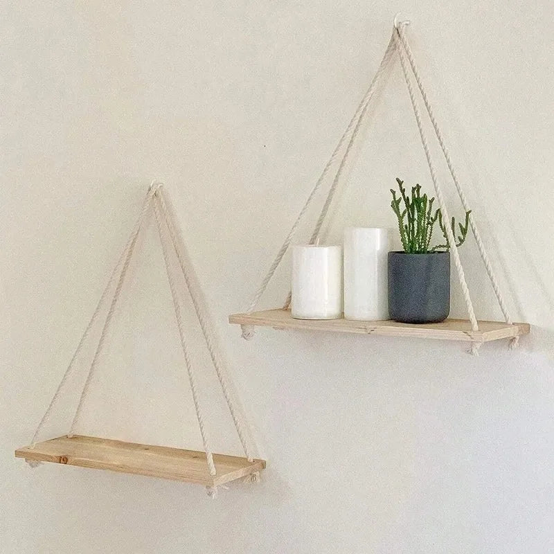 Minimalist wooden swing shelf mounted on the wall with hemp rope, used for organizing and displaying decorative items