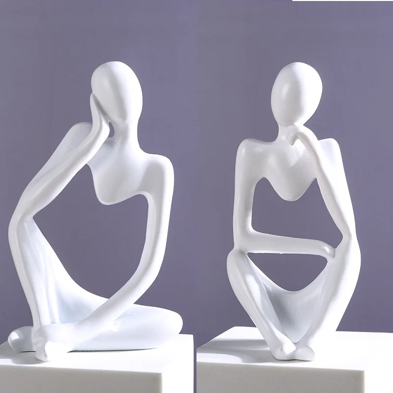 Abstract statue from The Thinker set placed on nightstand in cozy bedroom